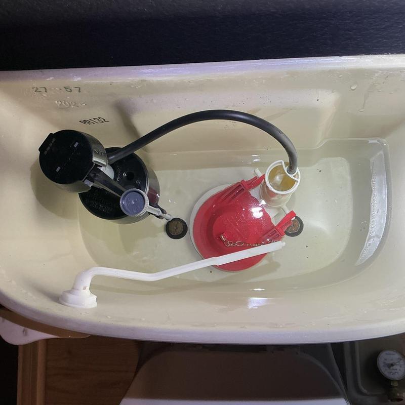Toilet fill valve and flapper inside tank