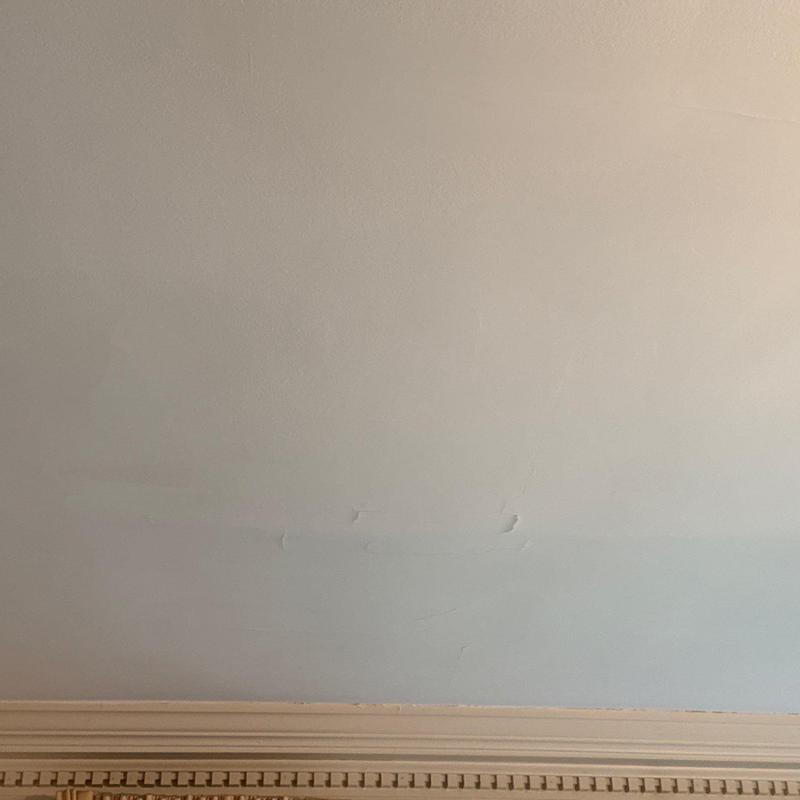 Interior wall paint with water damage and cracks