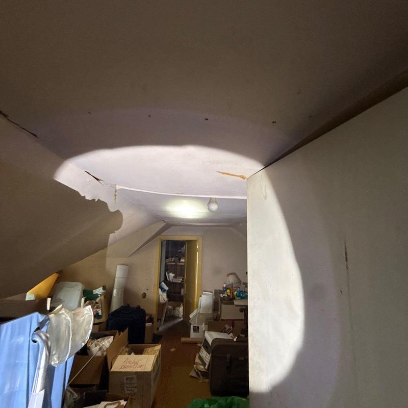 Ceiling drywall with water damage and cracks