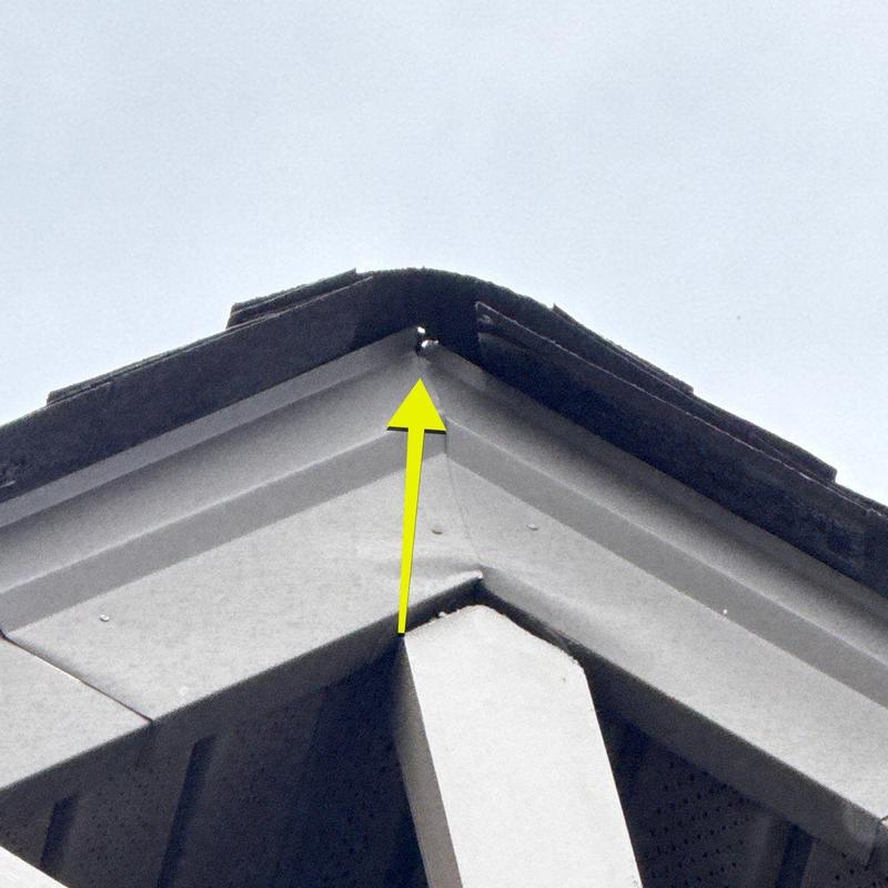 Roof flashing corner gap with yellow arrow pointing