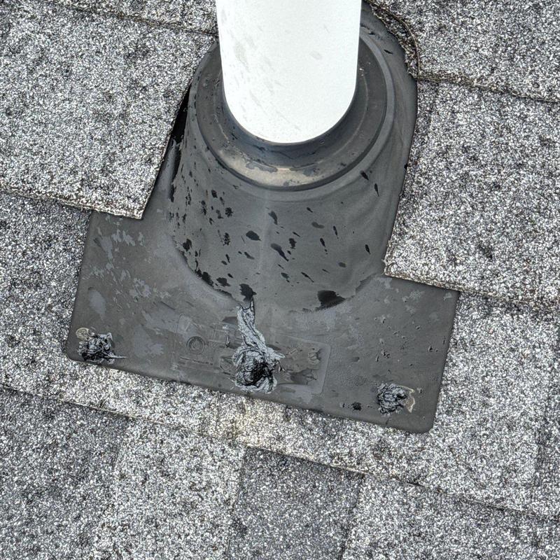 Roof pipe flashing with damaged sealant on shingles