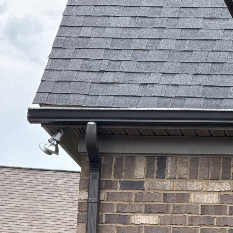 Asphalt shingle roof with gutter and downspout
