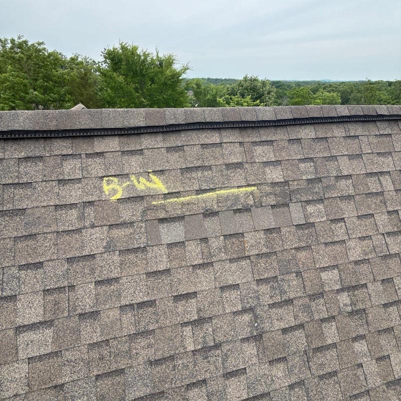 Asphalt shingles with yellow chalk markings on roof