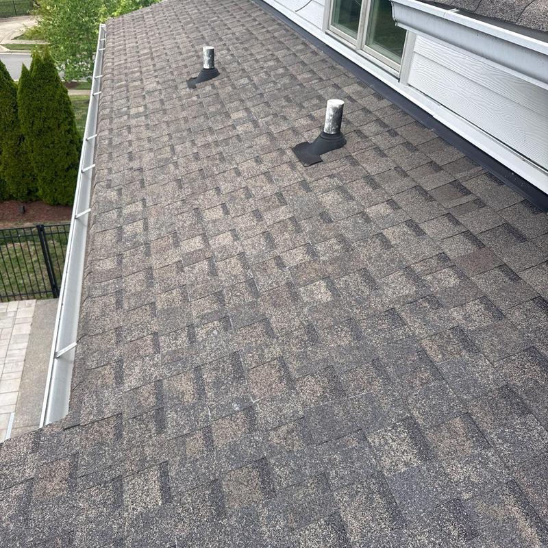 Asphalt shingle roof with vent pipes and flashing inspection