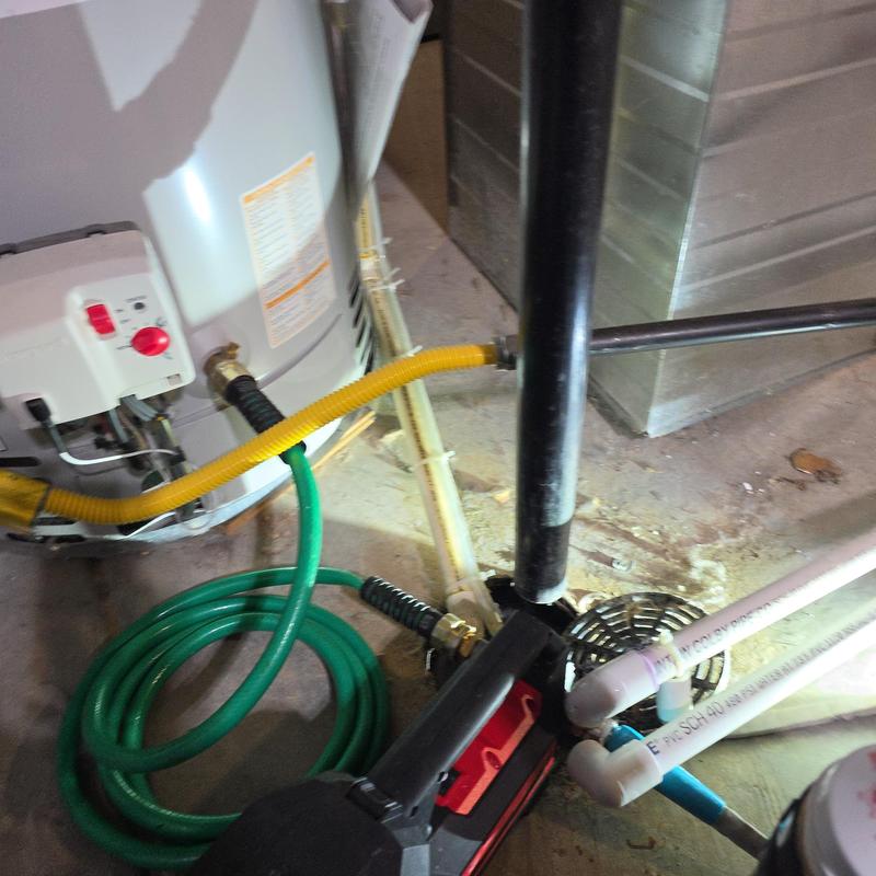 Bradford White water heater with copper and PVC pipes