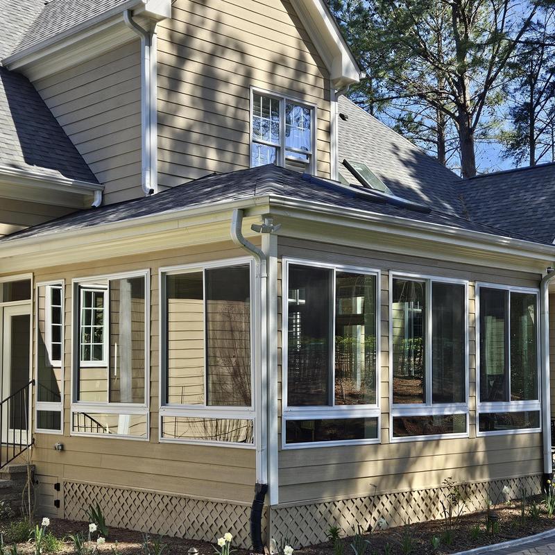 Sunroom installation with new siding and windows