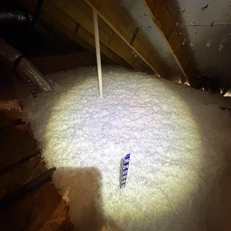 Attic loose-fill insulation with depth gauge and vent pipe