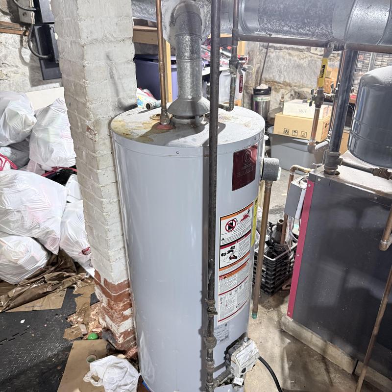 Gas water heater with vent pipe and plumbing connections
