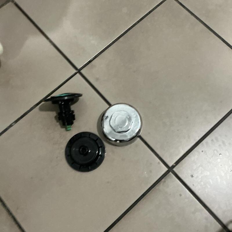 Sloan flushometer parts on restroom floor tiles Sloan flushometer parts on restroom floor tiles
