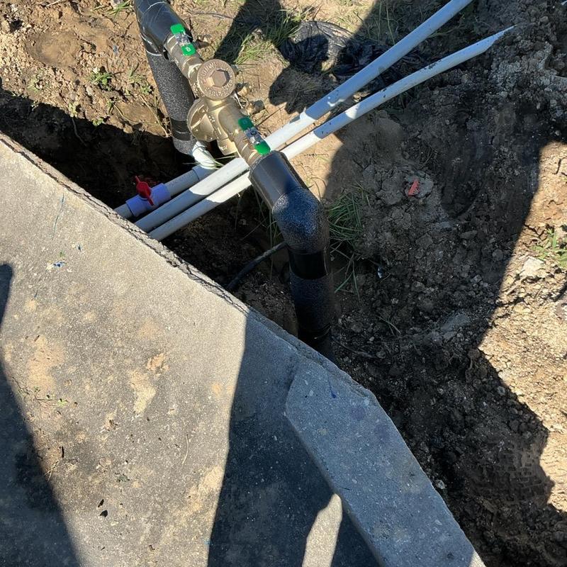 1-inch backflow preventer with PVC piping installation outdoors 1-inch backflow preventer with PVC piping installation outdoors