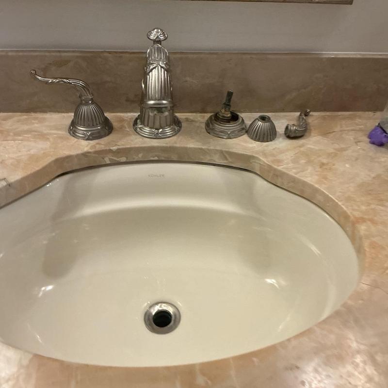 Antique bathroom faucet removed from sink countertop Antique bathroom faucet removed from sink countertop