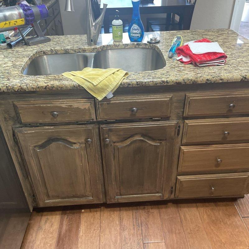 Kitchen sink and wood cabinetry with granite countertop Kitchen sink and wood cabinetry with granite countertop