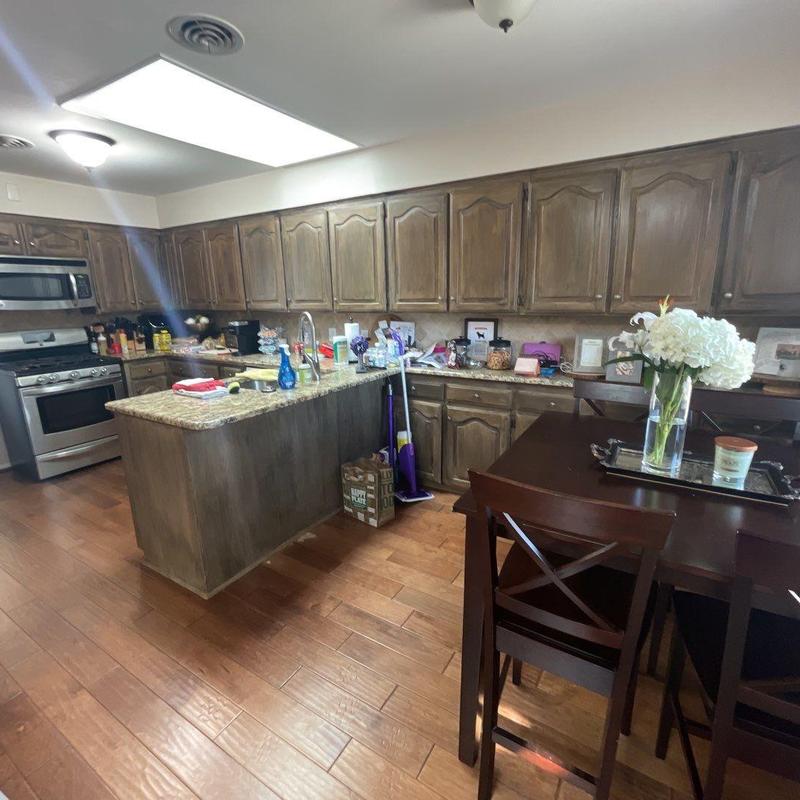 Granite countertop kitchen island with wood cabinetry Granite countertop kitchen island with wood cabinetry