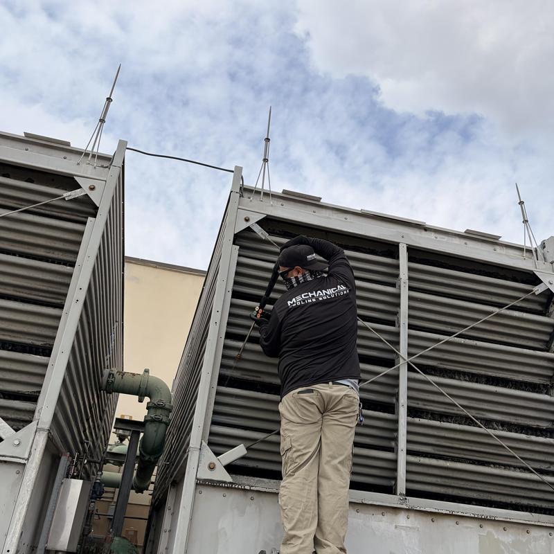 Cooling tower exterior power washing by technician Cooling tower exterior power washing by technician