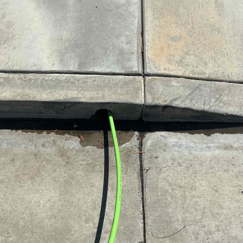 Area drain line with hydro jetting hose inserted