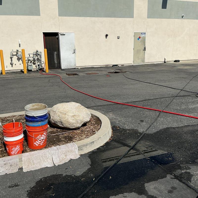 Grease trap mainline with hydro jet hose outdoors