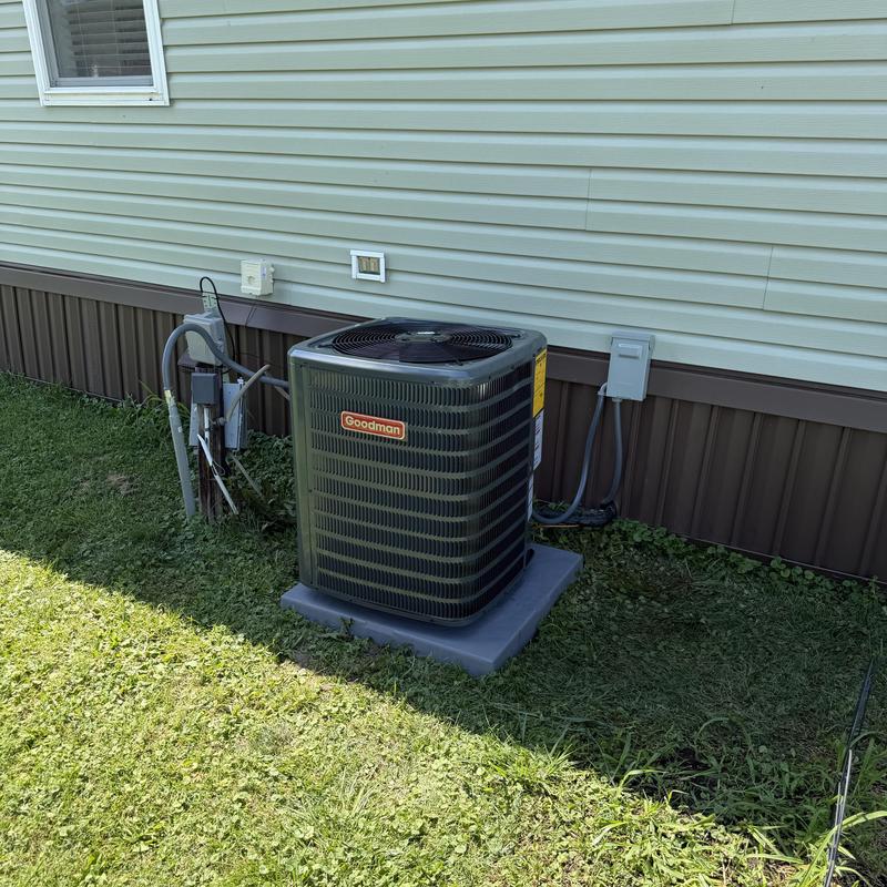 Goodman high-efficiency air conditioner unit outside home