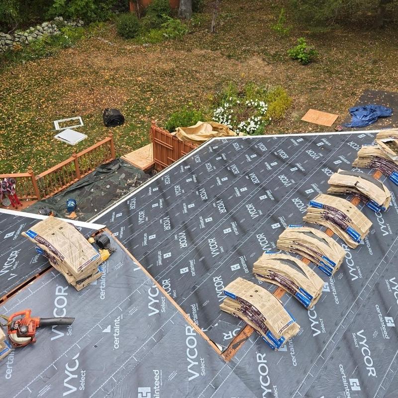 Roof underlayment with bundled shingles staged for install