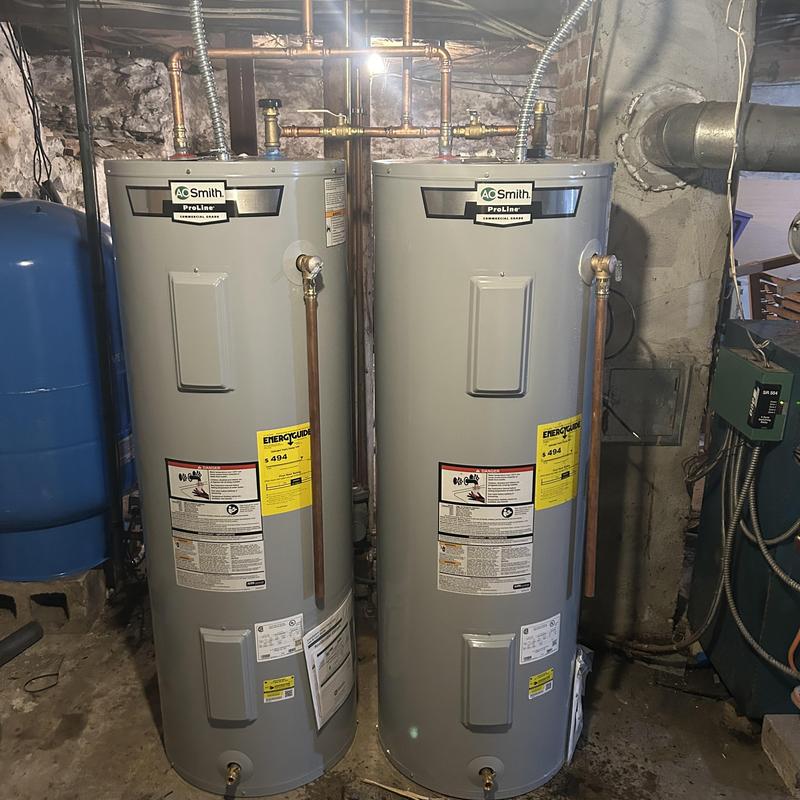 Two 50-gallon water heaters installed side by side Two 50-gallon water heaters installed side by side