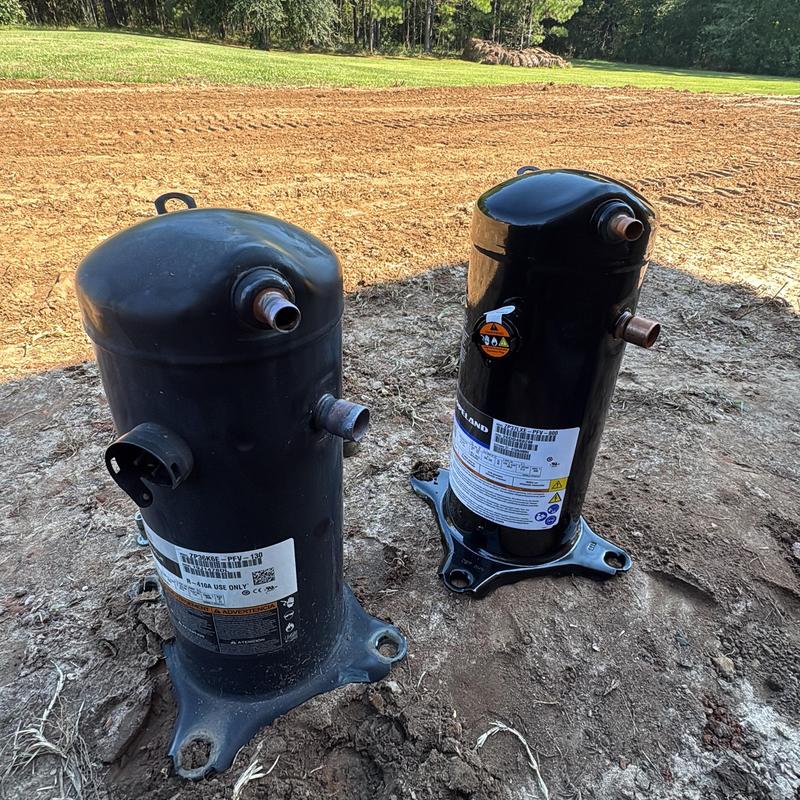 HVAC compressors on dirt ground outdoors HVAC compressors on dirt ground outdoors
