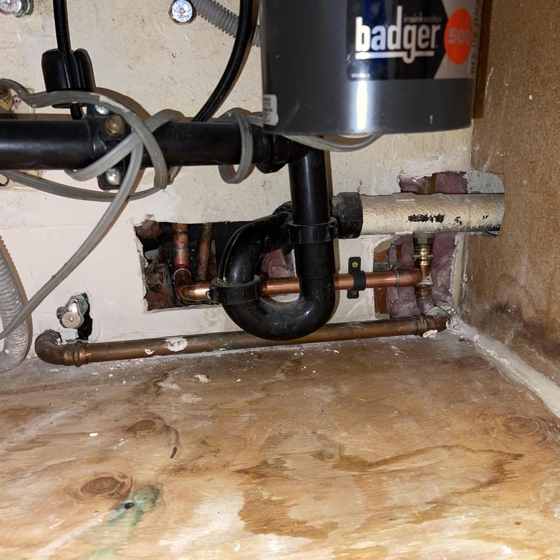 Copper water line reroute under sink with black drain pipe