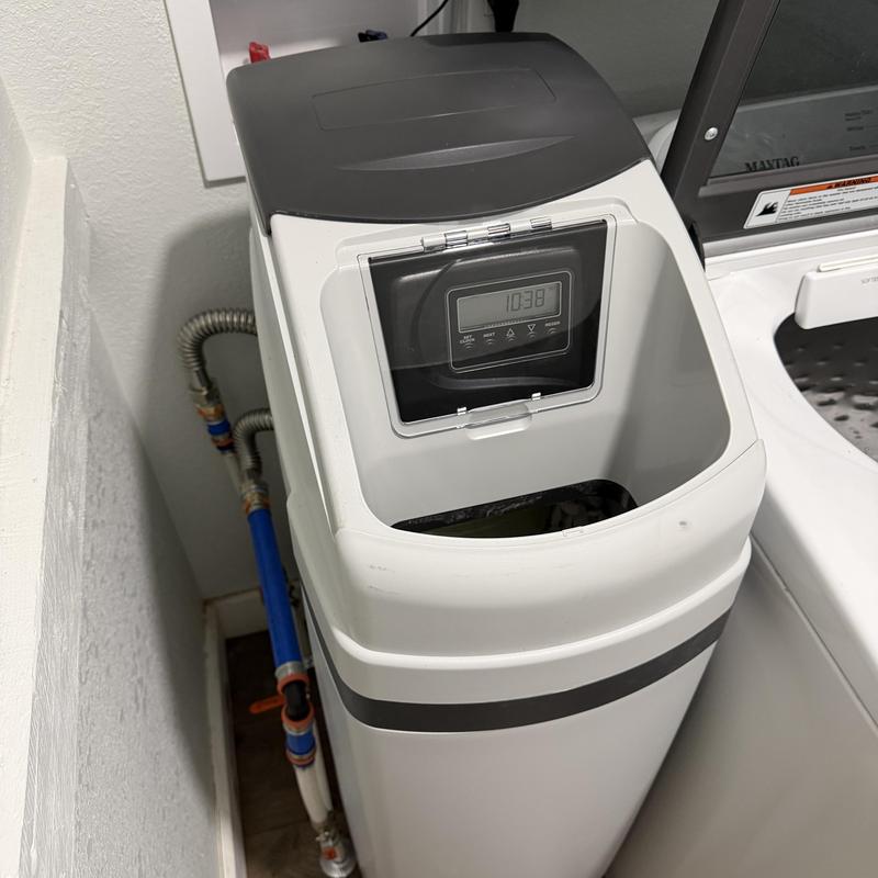 Water softener unit with plumbing in laundry room Water softener unit with plumbing in laundry room