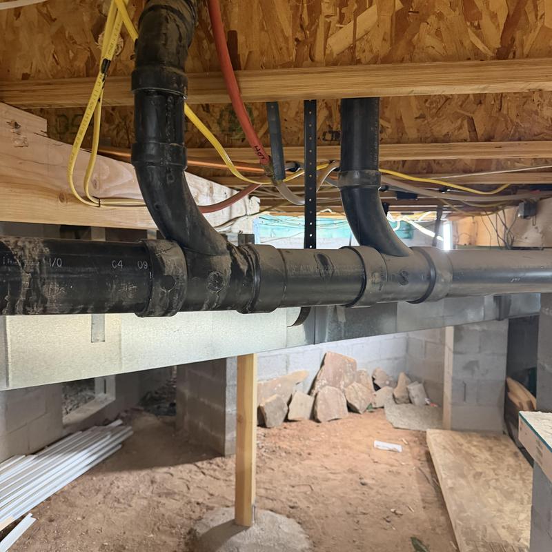 Sink and shower drain pipes in crawlspace installation Sink and shower drain pipes in crawlspace installation