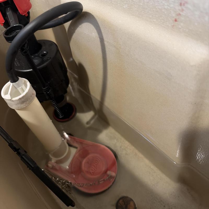 Toilet fill valve and flapper inside tank