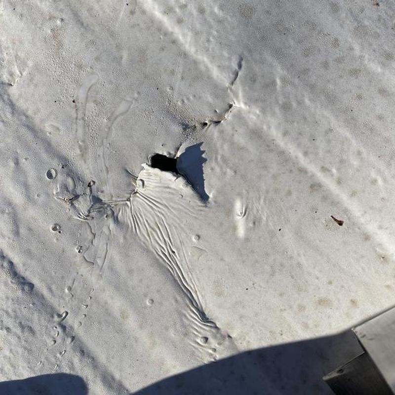Silicone roofing membrane with puncture hole in Coulterville