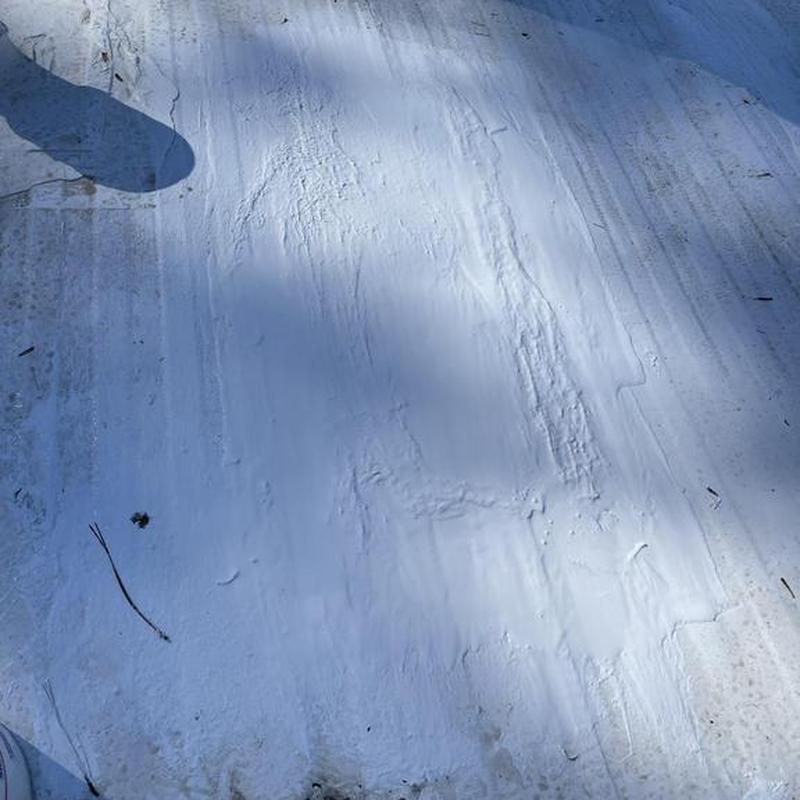 Silicone roofing coating on low slope roof surface