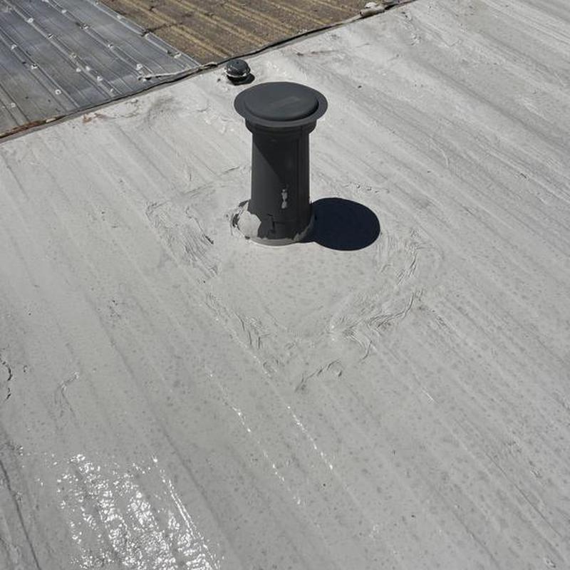 Silicone roofing with black vent pipe flashing