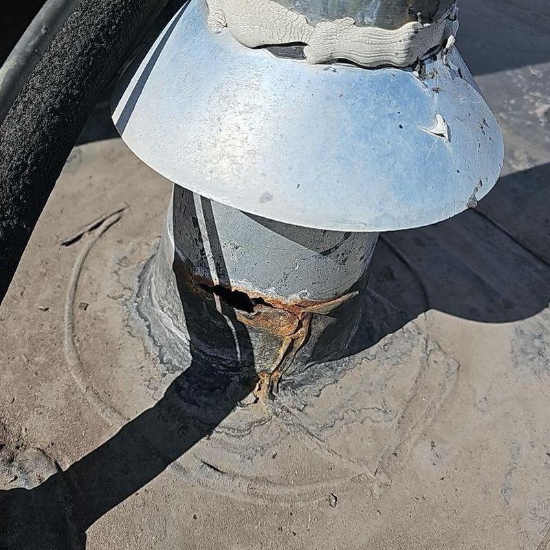 EPDM roof pipe flashing with rusted hole and damage EPDM roof pipe flashing with rusted hole and damage