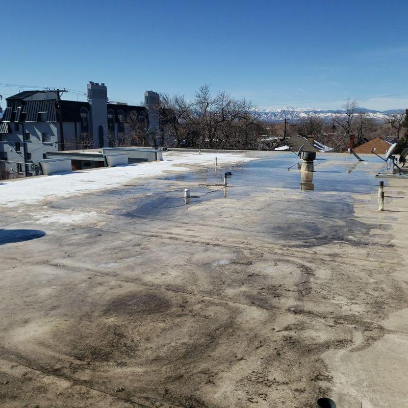 Flat roof with water pooling and drain vents Flat roof with water pooling and drain vents