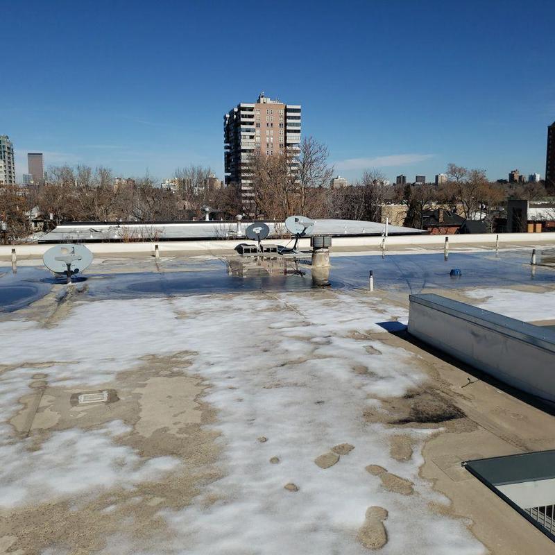 Flat roof with water pooling and satellite dishes Flat roof with water pooling and satellite dishes