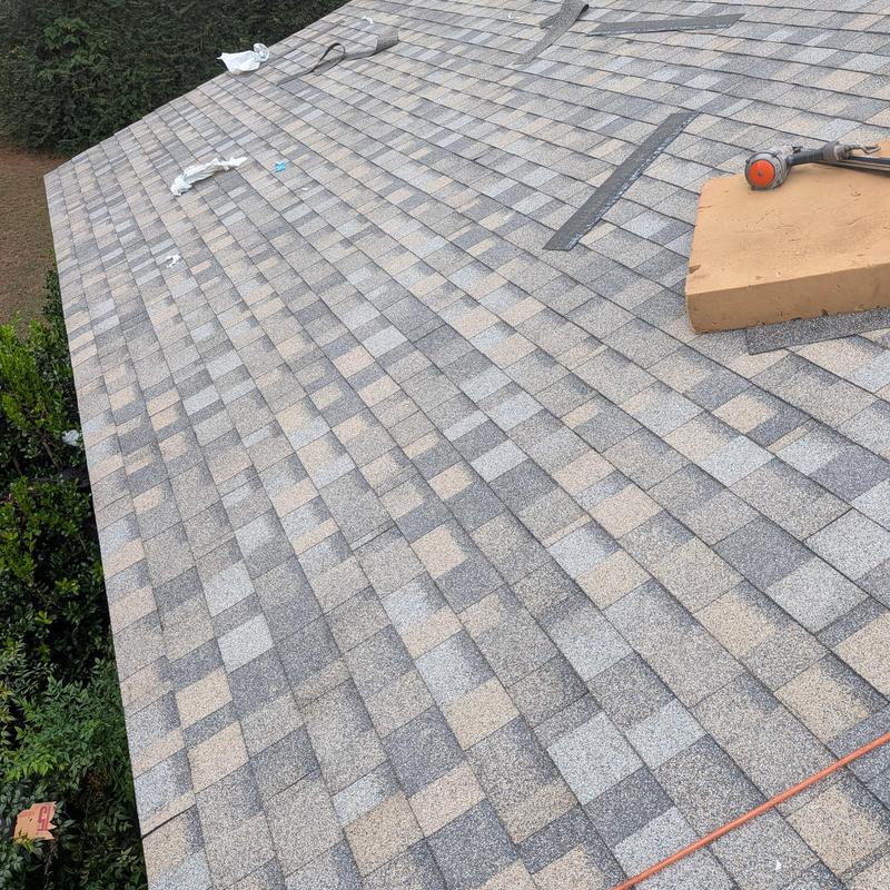Asphalt shingle roof dry inspection with tools on top