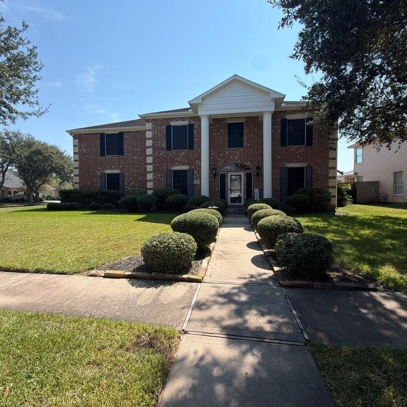 Brick residential home exterior with front walkway Brick residential home exterior with front walkway