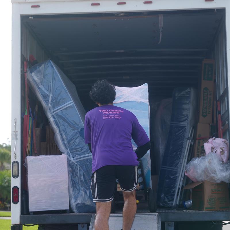 Mattresses and furniture loading into moving truck