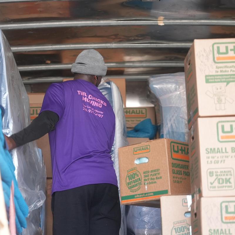 Furniture and boxes inside moving truck with mover