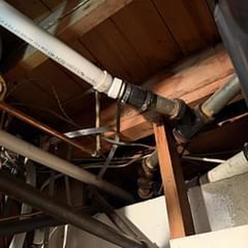 Tub waste and overflow piping in basement ceiling