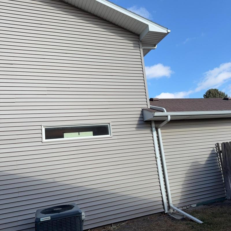 Gutter system with downspout on house exterior Gutter system with downspout on house exterior
