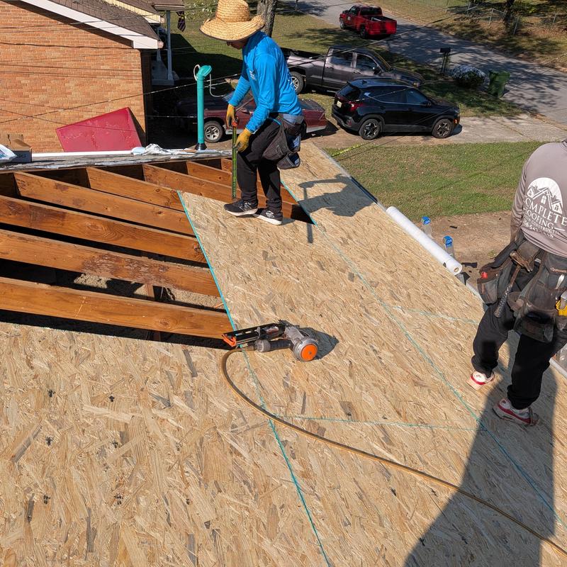 Roof decking installation with workers and tools
