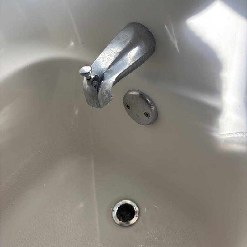 Tub spout and overflow plate inside bathtub Tub spout and overflow plate inside bathtub