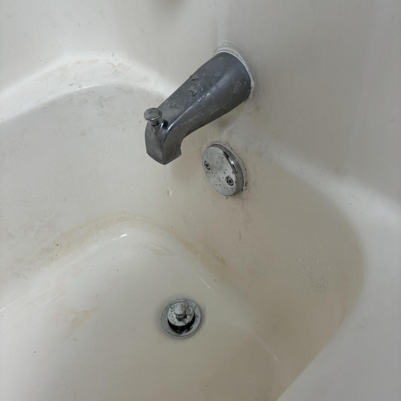 Tub spout and overflow plate with slight leaking drip Tub spout and overflow plate with slight leaking drip