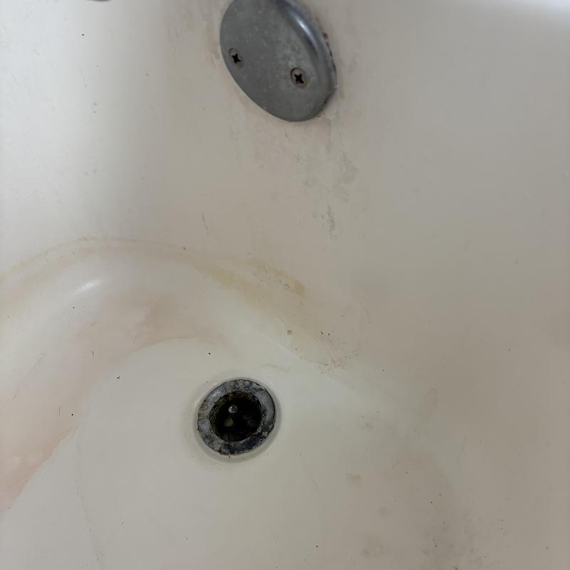 Tub drain and overflow with corrosion and stains Tub drain and overflow with corrosion and stains