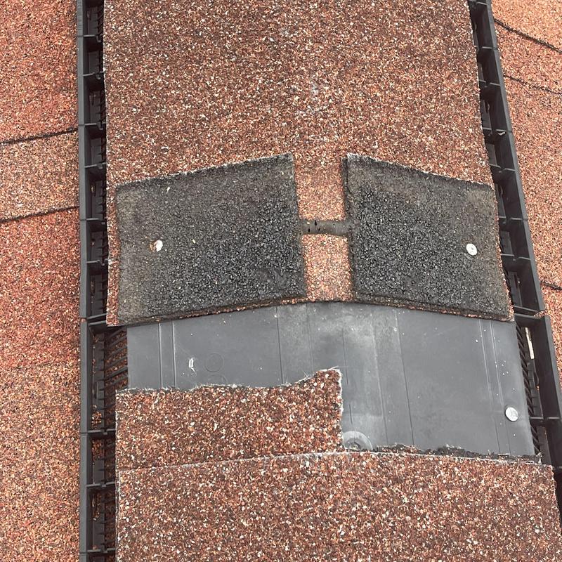 Roof shingles with damaged underlayment exposed