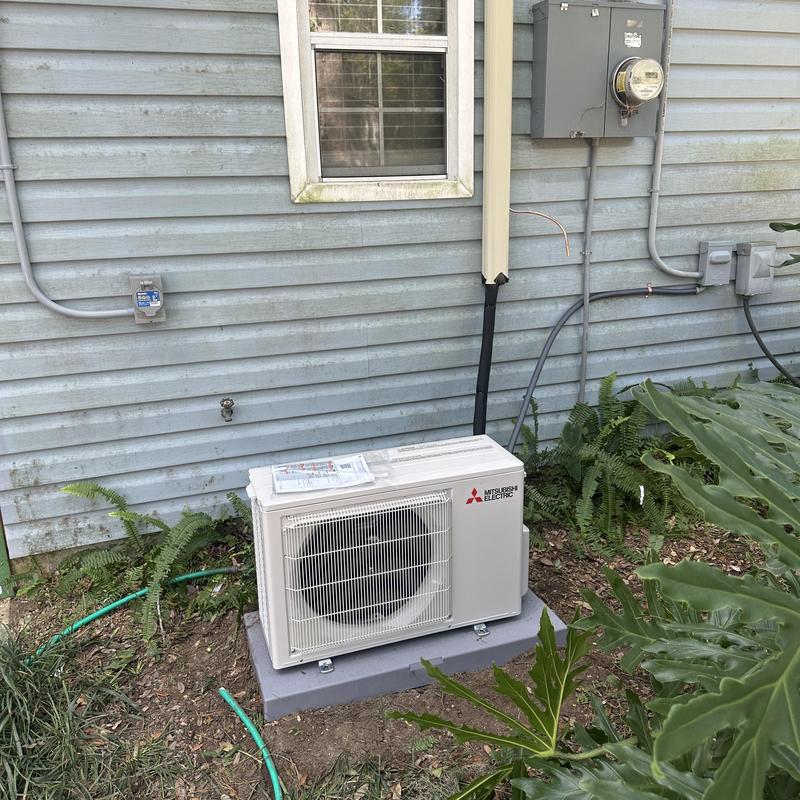 Mini split outdoor unit installed on concrete pad Mini split outdoor unit installed on concrete pad