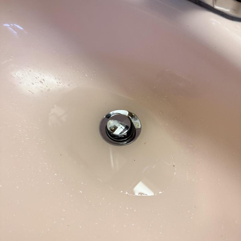 Lavatory drain and stopper with standing water