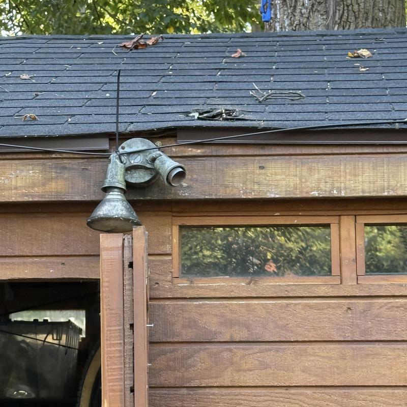 Shingles and plywood roof damage on wooden shed Shingles and plywood roof damage on wooden shed
