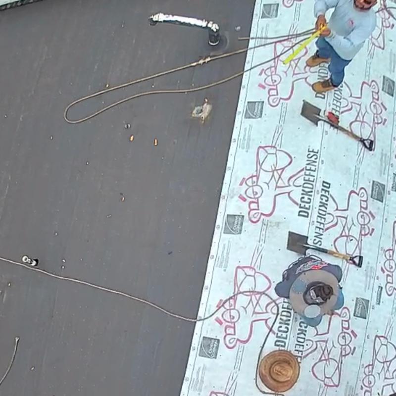Roof underlayment installation with safety ropes and tools Roof underlayment installation with safety ropes and tools