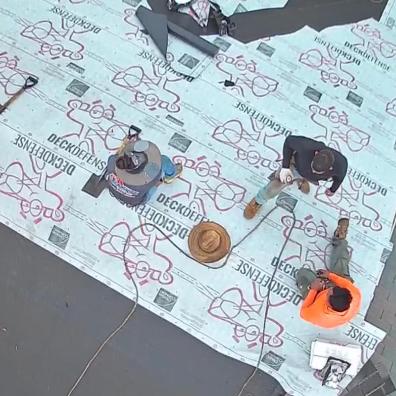 Roof underlayment installation with roofer team working Roof underlayment installation with roofer team working
